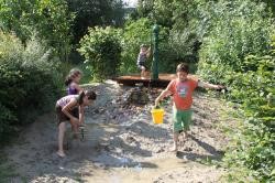 Spielende Kinder im Wasserspielbereich